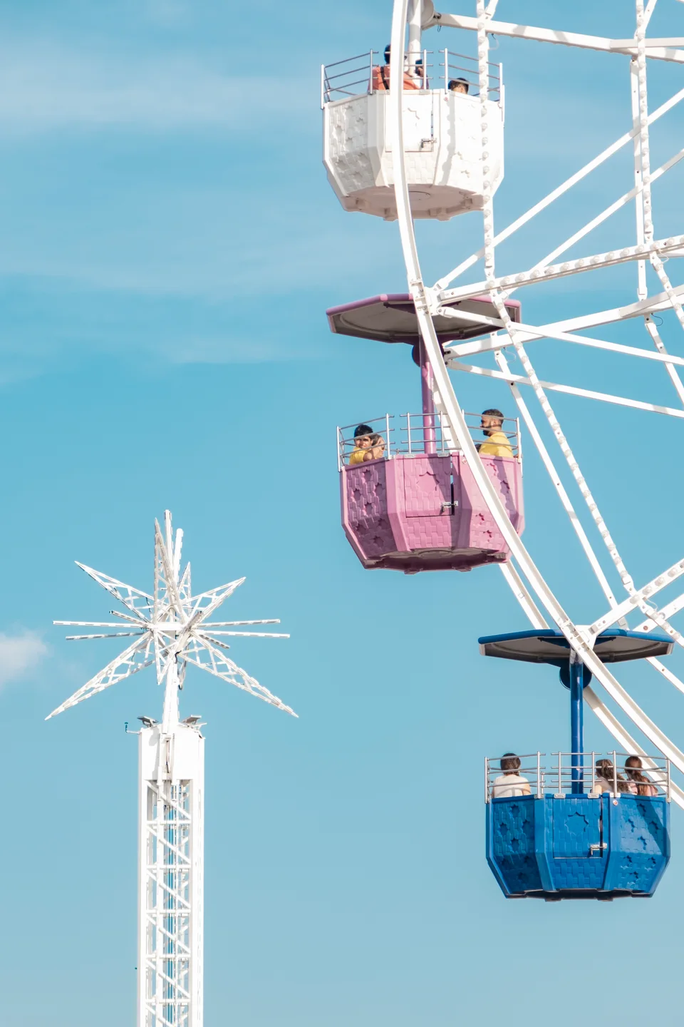 Colorful gondolas against a blue sky