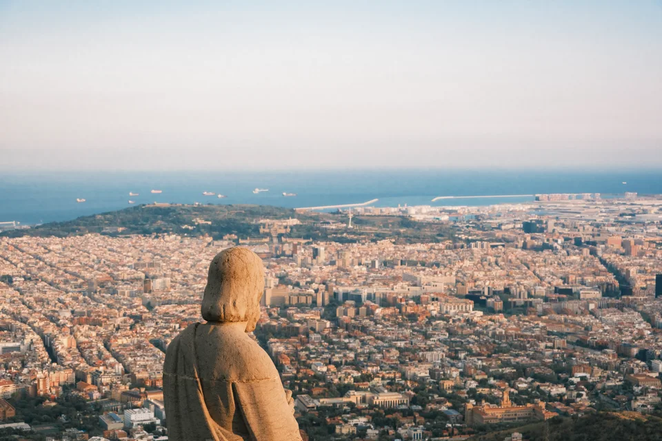 Stone figure overlooking the city and sea