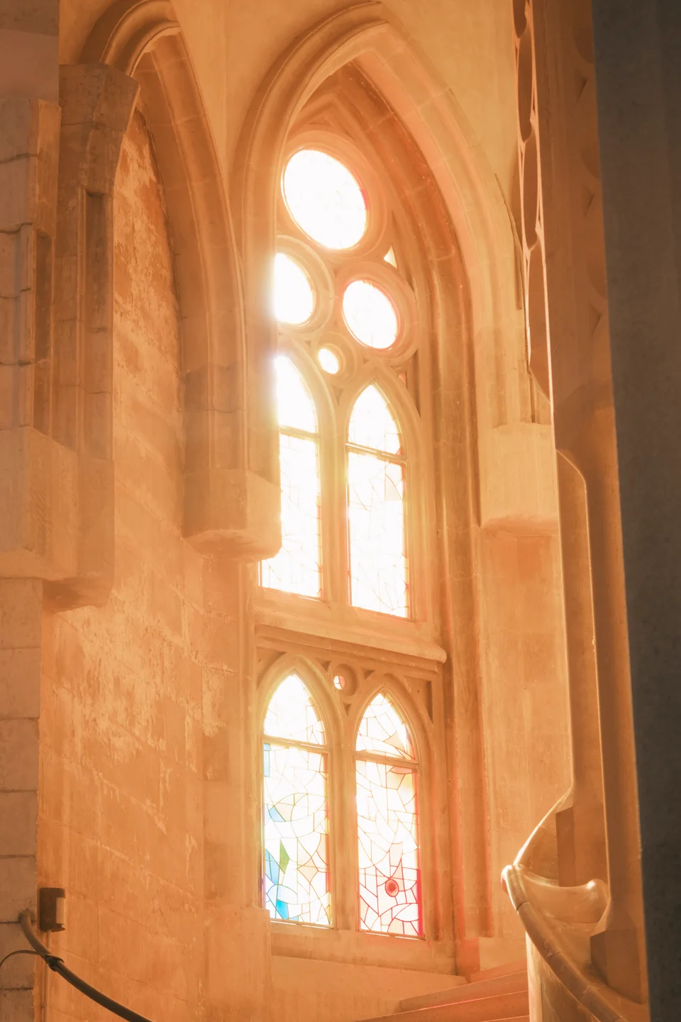 Warm light through a tall stained-glass window