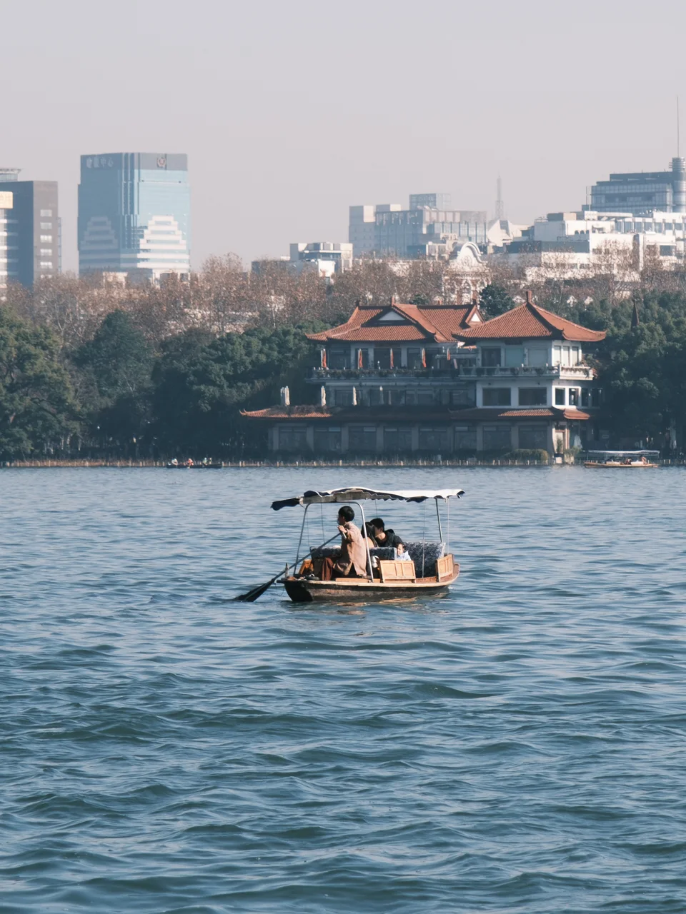 A small passenger boat crossing the lake